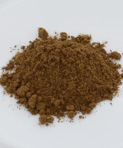 a pile of brown powder on a white plate